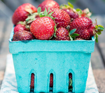 Small blue container of strawberries