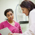 Woman talking to doctor in doctor's office