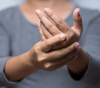 Closeup of someone holding their hand in their other hand